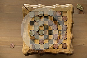 Game of checkers - US cents VS eurocents