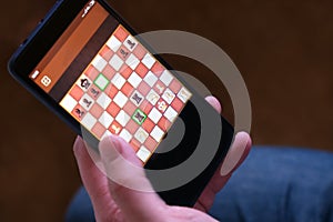 Game chess app for smartphone. The concept of business communication technology. Business strategy. Digital gadget