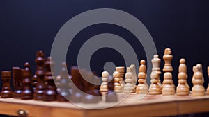 A game of chess, the beginning of a chess game two sides opposite each other.