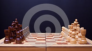 A game of chess, the beginning of a chess game two sides opposite each other.