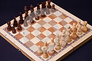 A game of chess, the beginning of a chess game two sides opposite each other.