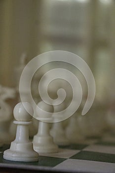 A game of chess in play with black and ivory pieces.