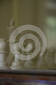 A game of chess in play with black and ivory pieces.