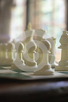 A game of chess in play with black and ivory pieces.