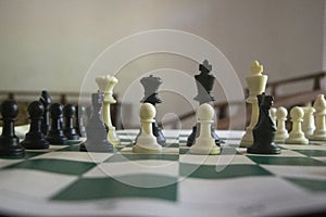 A game of chess in play with black and ivory pieces.