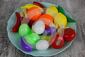 Fake food in a blue plate on a white background