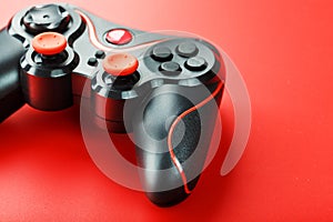 Game controller controller on red background. Device to control and control the game. close up