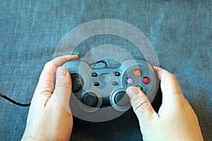 Game controller in the hands of a man