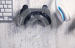 Game controller with keyboard and headphones. Playing video games