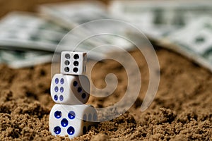 Game cubes made up of each other are on the sand, the background is blurred