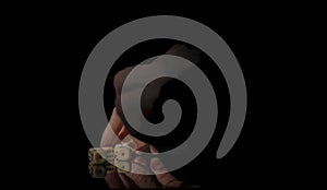 Game cubes on shiny black table with dark reflection