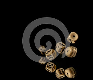 Game cubes on shiny black table with dark reflection