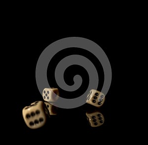 Game cubes on shiny black table with dark reflection