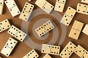 A game of dominoes on a brown background. Close-up. Selective focus