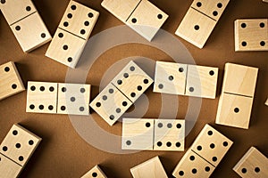 A game of dominoes on a brown background. Close-up. Selective focus