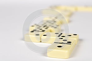 A game of dominoes on a light background. Close-up. Selective focus