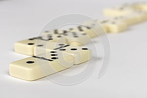 A game of dominoes on a light background. Close-up. Selective focus