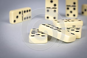 A game of dominoes on a light background. Close-up. Selective focus