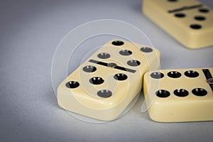 A game of dominoes on a light background. Close-up. Selective focus