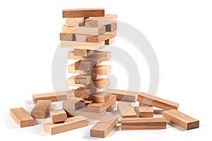 A game of logic and the ability to think. Jenga tower with wooden blocks on a white background