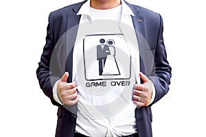 The game is over! newlywed in dark blue costume with opened shirt showing t-shirt with funny picture of marrieds