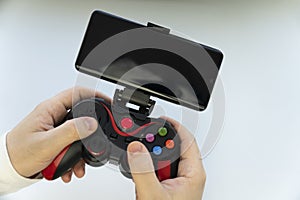 Game Pad with smartphone in hands isolated on white background. Mobile Gaming concept. a blank white screen on a smartphone for