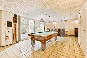 a game room with a pool table and a bar