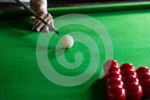 Game snooker billiards or opening frame player ready for the ball shot, athlete man kick cue on the green table in bar