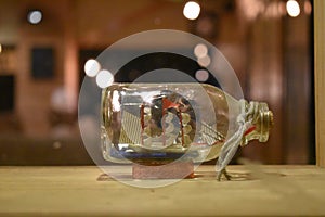 Game of thrones ship in a glass bottle on a wooden table at Srinagar, Jammu and Kashmir, India