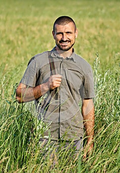 Gamekeeper with a rifle in a field photo