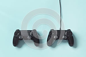 Gamepad connected wire from the game console on blue background. Concept of game tournaments photo