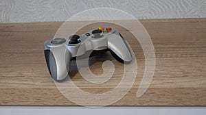 Gamepad on table in loft style on white background. Digital technology background. Empty space.