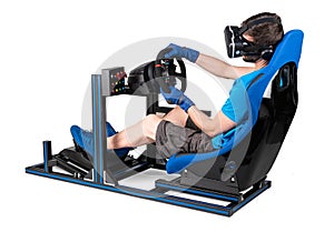 Gamer in blue tshirt with VR virtual reality glasses training on simracing aluminum simulator rig for video game racing.