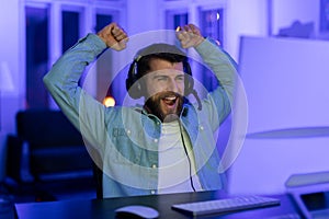 Gamer celebrates a win with raised arms