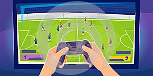 Gamer hands with a console controller. Playing soccer game on a big screen