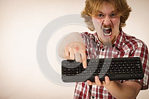 Gamer man holding computer keyboard