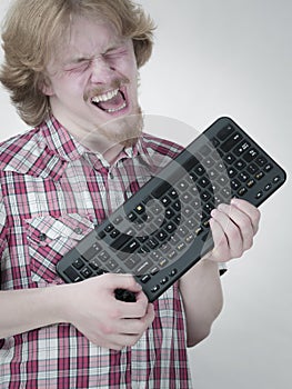 Gamer man holding computer keyboard