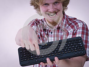 Gamer man holding computer keyboard