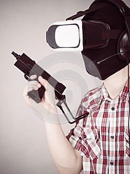 Gamer man wearing VR holding gun