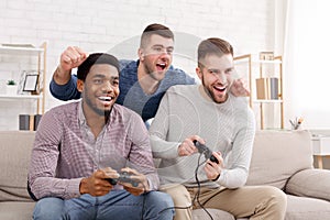 Gamers. Happy men playing video games at home