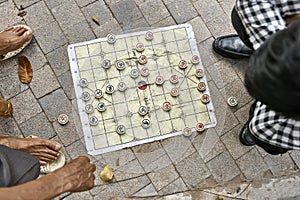 Gamers playing traditional asian chess outdoors in Hanoi