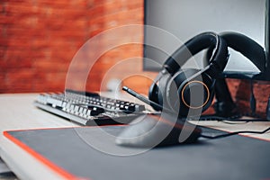 Gaming arena background with mouse gear headphones computer, focuse on headphones selected focuse