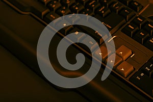 Gaming computer keyboard on a dark background. Up and down buttons on a computer keyboard