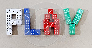 gaming dice in different colors spelling play