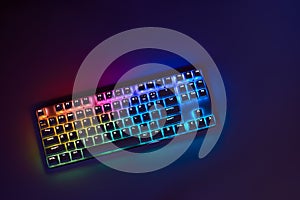 Gaming keyboard with RGB light. White mechanical keyboard. Gamer`s workspace, neon light