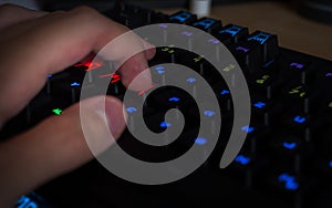 Gaming keyboard with rgb lighting guy having his hand in gaming position