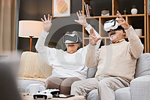 Gaming, virtual reality and senior couple with headset play online game with VR, technology and smile. Future, elderly