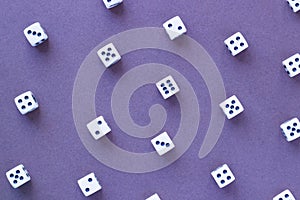 Gaming white dice pattern on purple background in flat lay style.