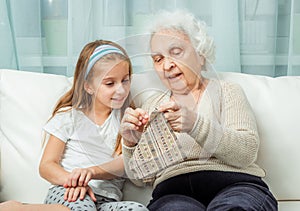 Ganddaughter learning to embroider with granny