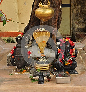 Ganesh and a devi statue. Small Indian worship shrine